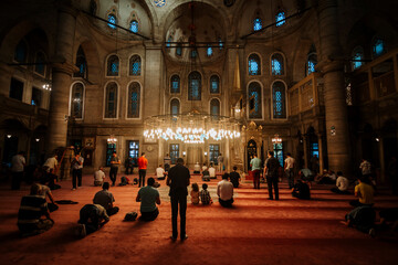 Eyup Sultan Mausoleum Mosque interior view. Many people praying. islam