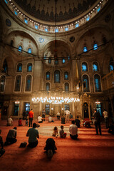 Eyup Sultan Mausoleum Mosque interior view. Many people praying. islam