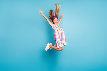 Full length body size view of her she nice attractive lovely pretty charming cute glad cheerful cheery free girl jumping enjoying leisure isolated over bright vivid shine vibrant blue color background