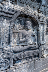 Fototapeta na wymiar The stories from Mahayana Buddhist Sutras carved on the relief panels of Borobudur Temple (750AD)