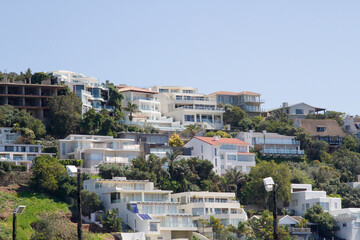 Fototapeta na wymiar Houses on a hillside in Plettenberg Bay, South Africa 