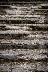 Old ruined staircase leading up the slope. Close-up of an abandoned falling apart ladder in a natural park