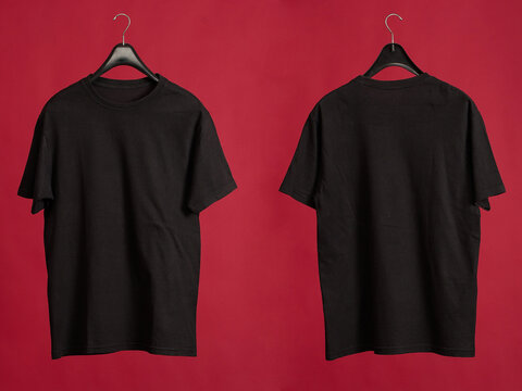 Exclusive hanger with empty black t-shirt hanging isolated on a red background. Blank black male tshirt template, from two sides,  for your mockup design to be printed.