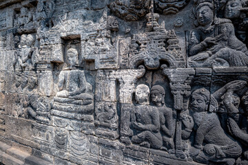 Fototapeta na wymiar The stories from Mahayana Buddhist Sutras carved on the relief panels of Borobudur Temple (750AD)