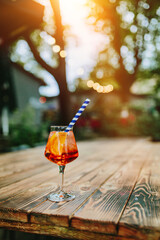 Glass of Aperol Spritz and blue straw, Italian Cocktail