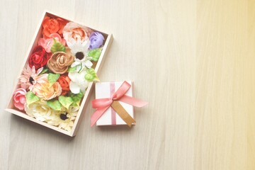 Gift box and wooden flower box On a white wooden background,copy space for text
