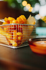 Basket of crispy French Fries on a cafe table