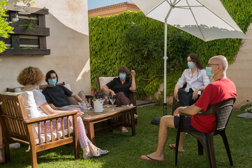 A happy family celebrates a birthday party in the garden of their home. Concept of social distance...