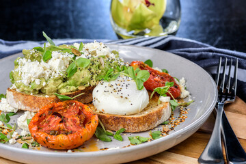 Avocado Toast featuring smashed avocado, grilled tomatoes, boiled egg on sourdough toast