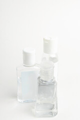 Obraz na płótnie Canvas Three Pocket-Size Transparent Hand Sanitizer Dispenser Plastic Bottles