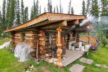 Yukon river, Yukon Territory, Alaska, USA. Wooden cabin in the remote wilderness of Alaska.