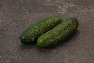 Green fresh cucumbers over background