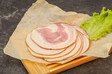 Sliced Pancetta sausage over board