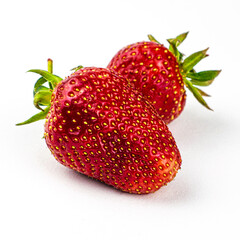 two whole ripe red strawberries on the white background