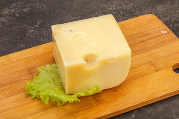Emmental cheese over wooden board