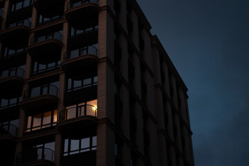 Obraz premium Modern architecture. Skyscraper. Light in the window. Beautiful house. Night scene.