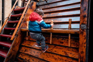 Toddler climbing up in the ship yard