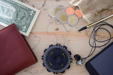 Fototapeta na wymiar Background, small space for text, with travel content, compass, country money, wallet and other objects.