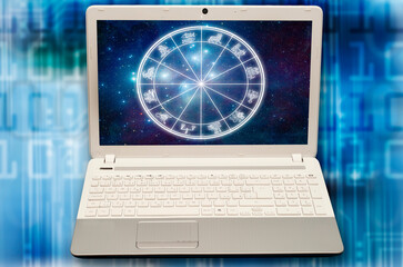 laptop notebook with horoscope with zodiac signs and stars on screen like astrology and internet, on-line astrology and app astrology concept 