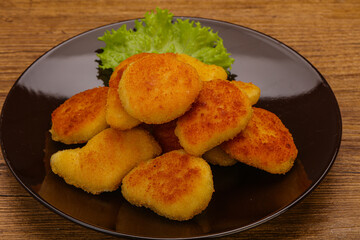 Fried chicken nuggets served salad leaves