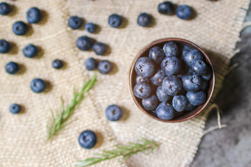 Obraz na płótnie Canvas Blueberry antioxidant superfood in a bowl on sackcloth background. Healthy eating and nutrition concept.