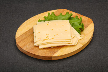 Sliced yellow cheese over board