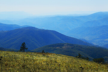 Mountain peaks landscape. Hiking. Blue degrade background on a sunny day. Excursion and mountains.