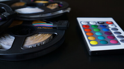 Led strip coils closeup. Diode with control panel for switching colors on dark background.