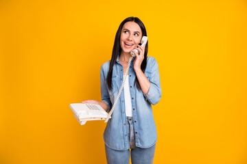 Portrait of her she nice-looking attractive pretty charming cheerful cheery girl calling friend discussing gossip rumor isolated on bright vivid shine vibrant yellow color background