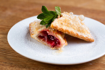 fried pie with strawberries, mint and powdered sugar