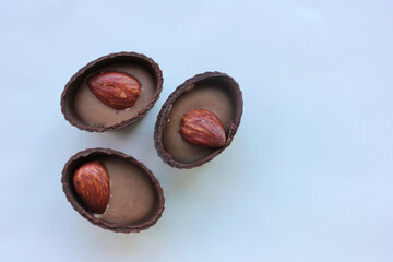 Chocolate candies with almond on white background

