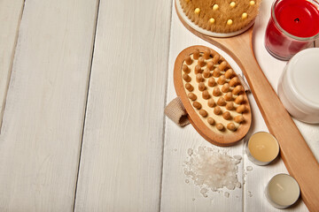 Green bath salts (for feet), wooden massage brush for head, candles and oils, massage brush for body. Natural Spa, cosmetic care, zero waste concept. Top view, place to copy.