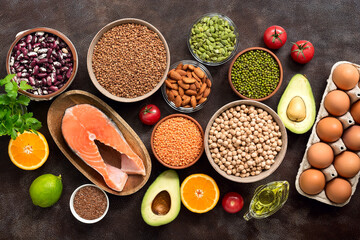 Ingredients for a healthy balanced diet food : fruits, vegetables, legumes, fish, eggs, seeds. Concept of healthy eating and clean food. Top view, flat lay,