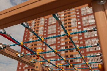 tall brick house peeks through the net at the playground
