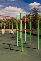 Fototapeta premium green and red horizontal bars on a playground in the summer 