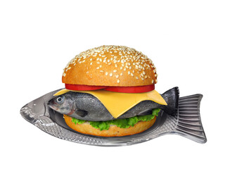 There is a big fresh fish burger on a fish shaped plate. White background. Isolated.