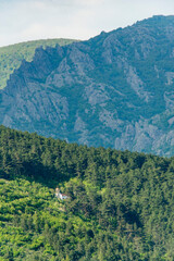 A serene place in the mountain - small church with a shiny golden dome in the middle of a lush...