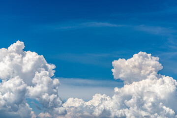 Naklejka na ściany i meble White fluffy clouds on blue sky. Soft touch feeling like cotton. White puffy clouds cape with space for text. Beauty in nature. Close-up white cumulus clouds texture background. Sky on sunny day.