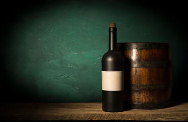 the still life with red wine, bottle, glass and old barrel