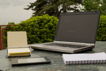 a laptop on an outdoor work table