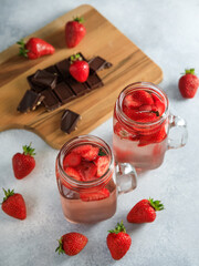 Strawberry drink with berriesand wooden board with chocolate. Diet drink, healthy concept