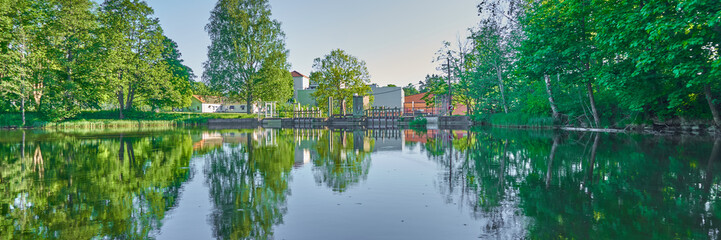 Obraz premium The green trees reflected in the water, Spring, Sweden