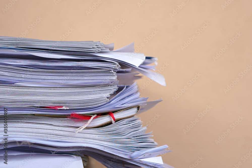 Poster stack of business report paper files on desk