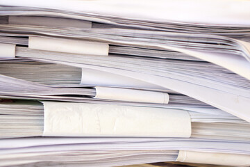 Stack of business report paper files on desk