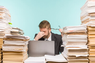 Close-up image of a stressful businessman tired from his work on the foreground