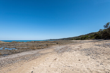 Empty Large Rocky Coastal Seaside Scene and Beach on a Sunny Day