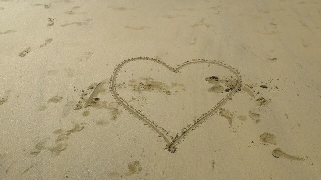 Heart Drawn On The Sand Near The Ocean. - static shot