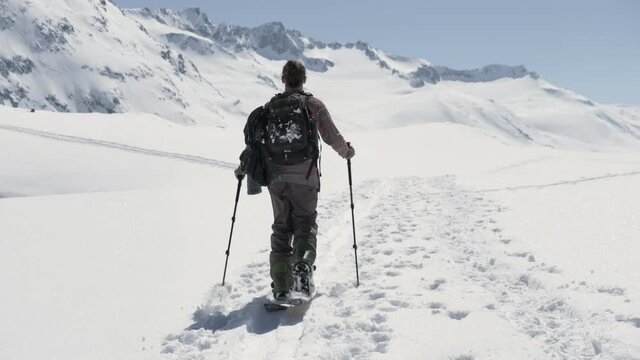 Splitboarder hiking a mountain in Switzerland.