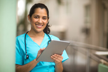 Happy Hispanic medial provider at work stock photo.