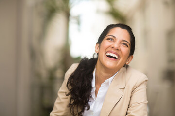 Hispanic business woman smiling outside stock photo